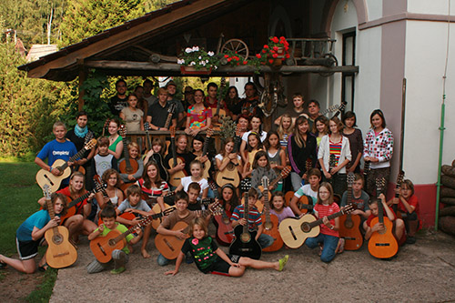 mass photo of summer camp with guitar from 2012