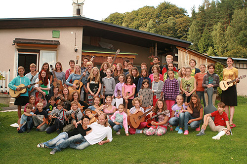 mass photo of summer camp with guitar from 2013