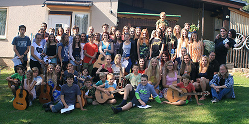 mass photo of summer camp with guitar from 2016