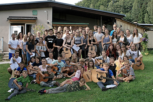 mass photo of summer camp with guitar from 2017