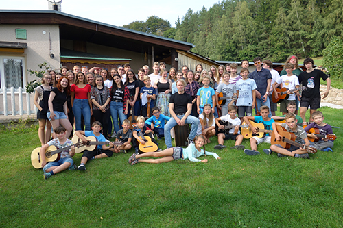 mass photo of summer camp with guitar from 2019