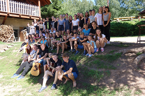 mass photo of summer camp with guitar from 2020