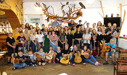 mass photo of summer camp with guitar from 2021