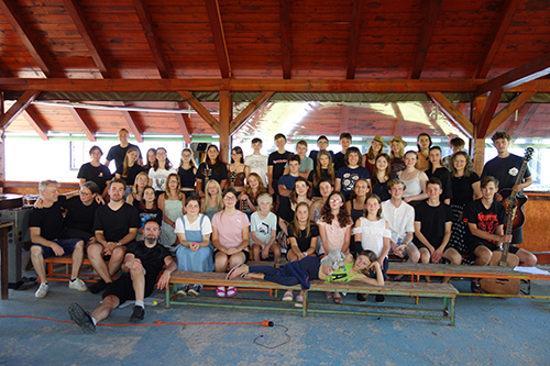 mass photo of summer camp with guitar from 2024